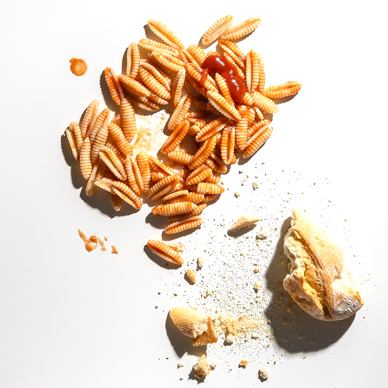 Dettaglio di pane e pasta in decomposizione trasformato in immagine artistica.